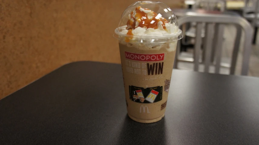 an iced coffee is on a table and is ready to be eaten