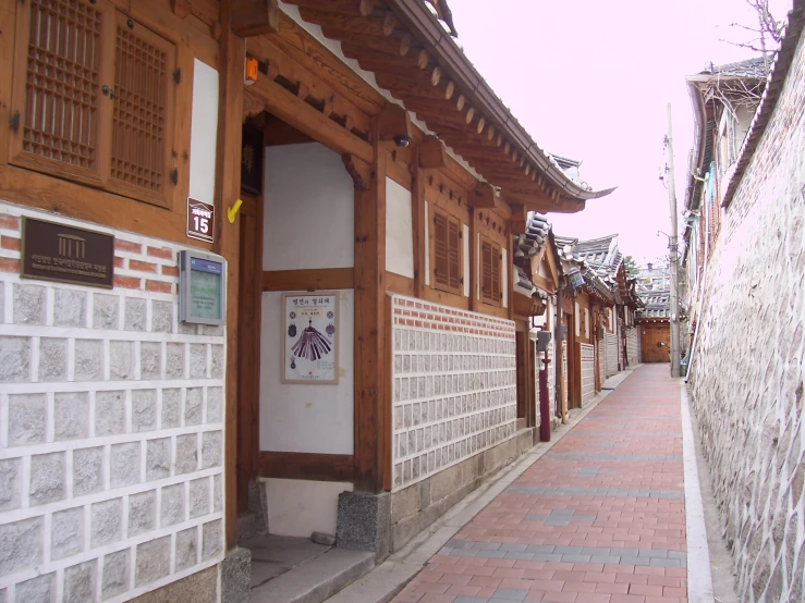 the building is covered with wood and white bricks