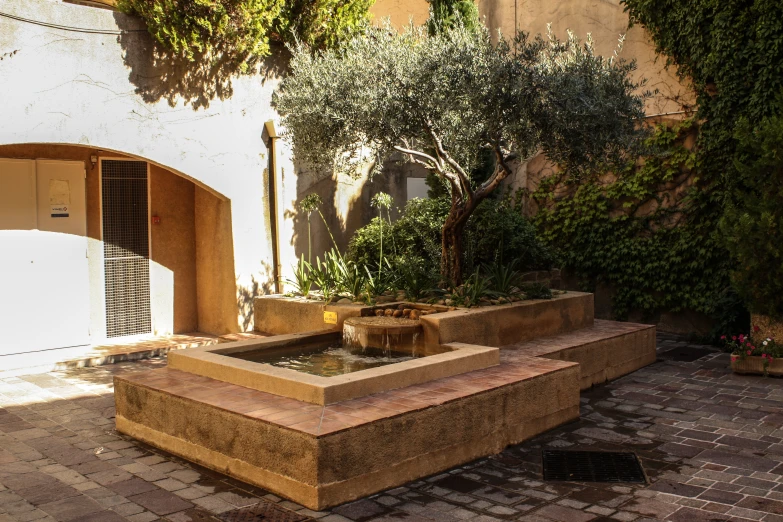 an outdoor seating area with water and trees