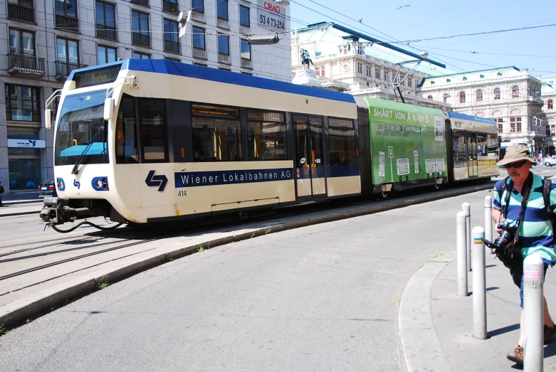 a person walking near the trolley car on the street