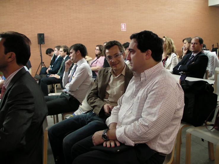 a group of men sitting down in chairs