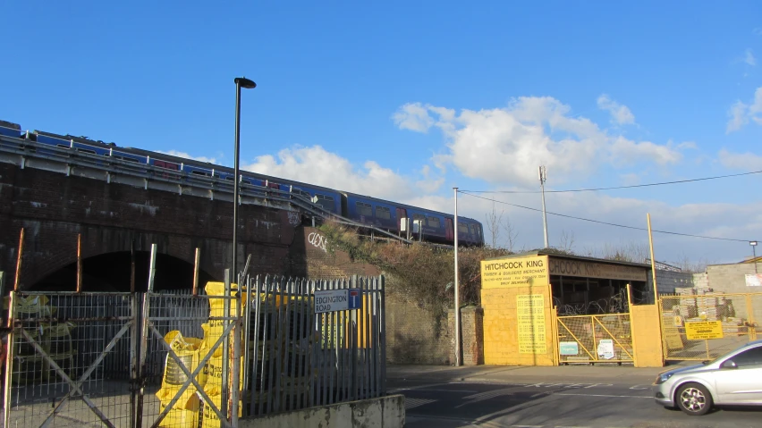 a yellow box sitting next to a bridge and road