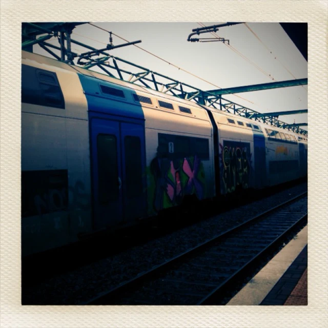 an electric train with graffiti painted on it