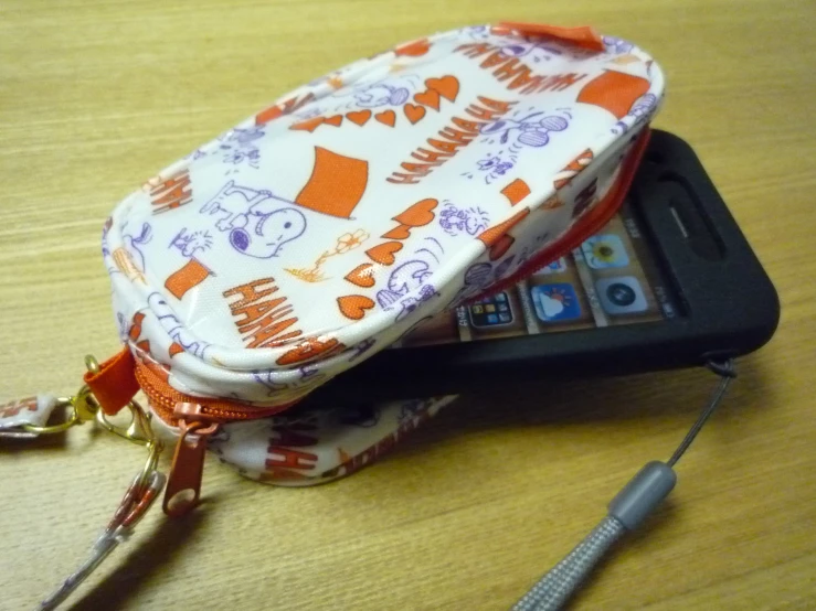 an orange and white cell phone wallet on a table