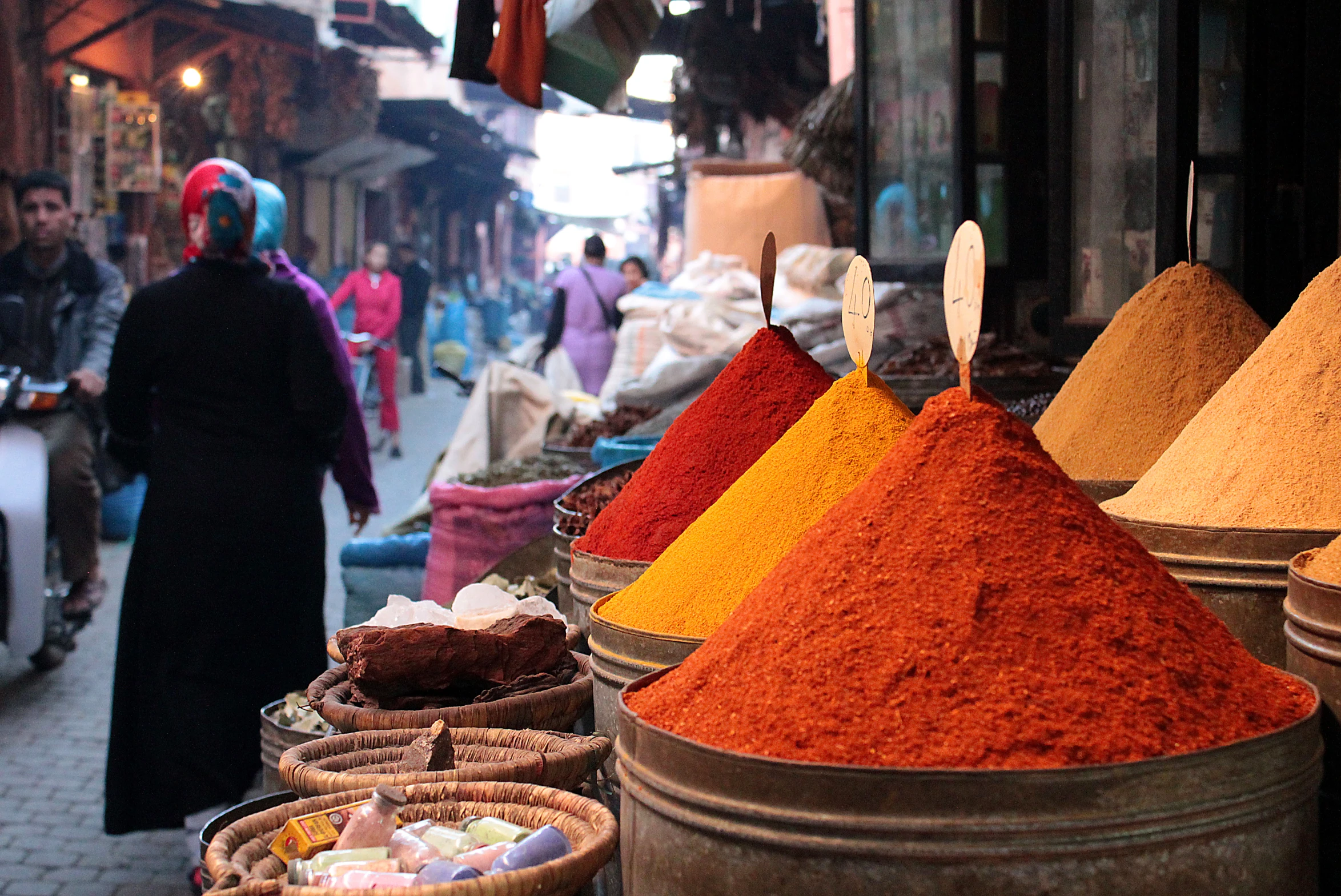 an outdoor market with lots of different colored spices