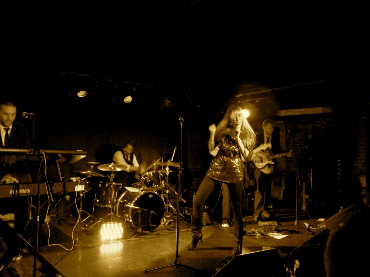 three musicians on stage performing on a stage