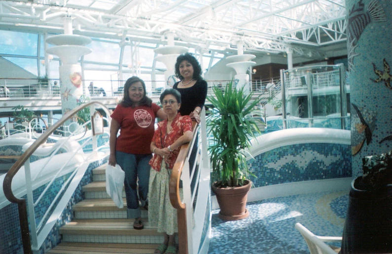 a group of women standing next to each other on the stairs