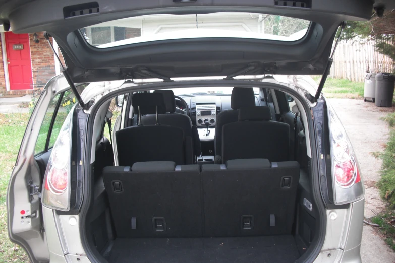 the back end of a hatchback car with boot space open