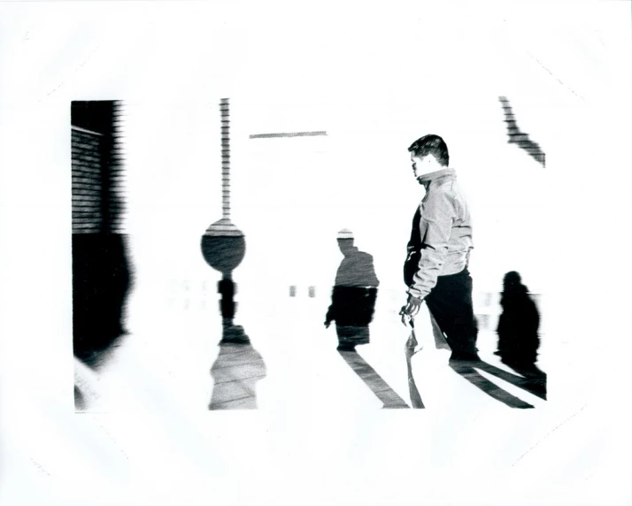 a man walking through a room while holding a white object
