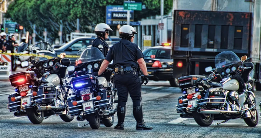 the motorcycle cops are directing traffic on the street