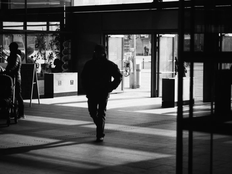 a man is walking out of a large building