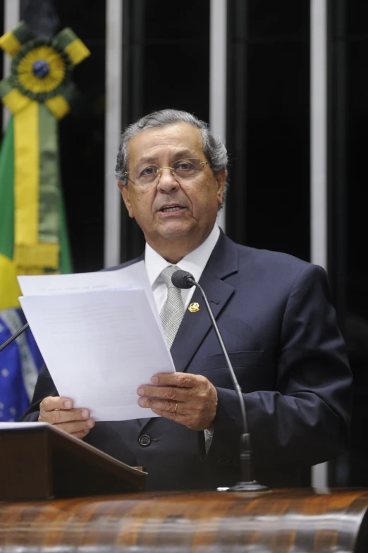 a man in a business suit holds papers