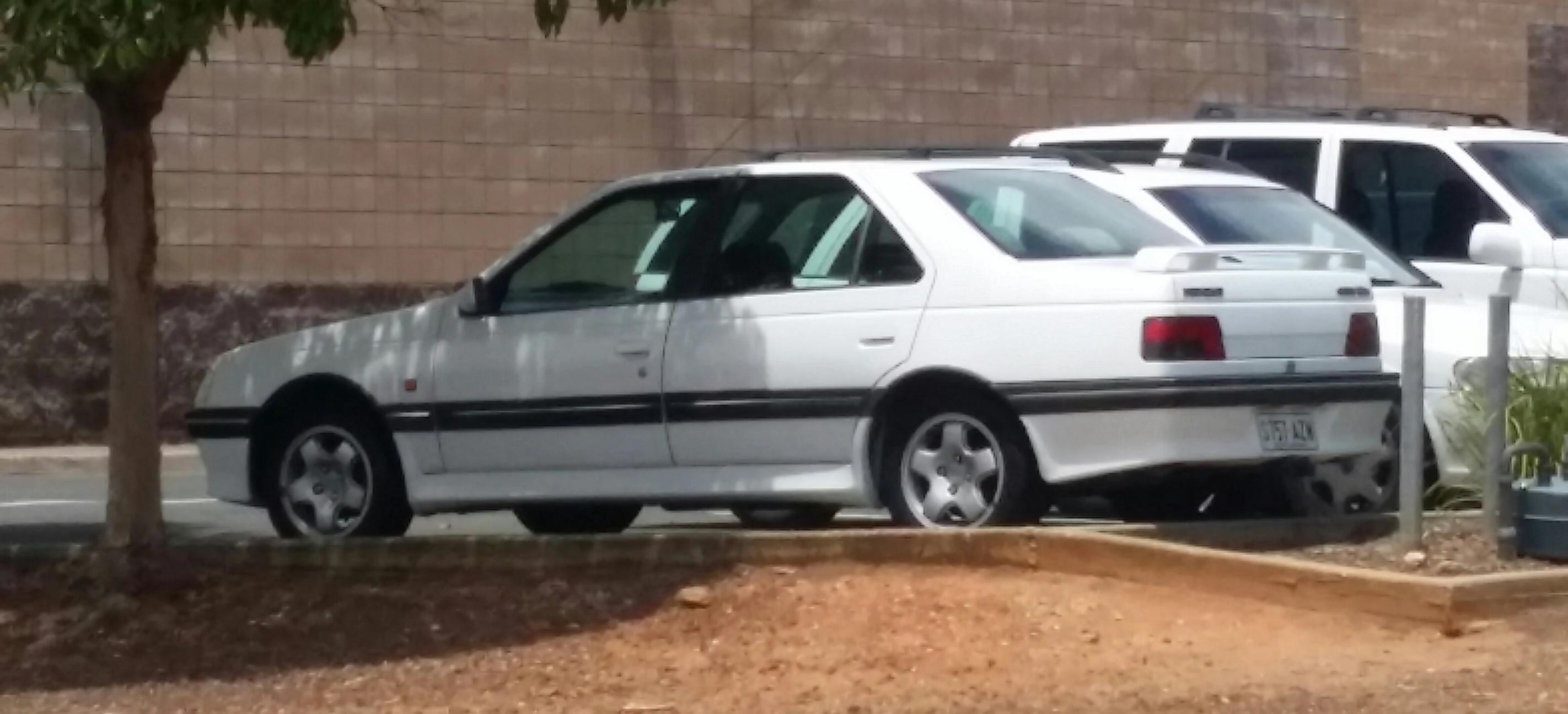 two cars parked next to each other on a street