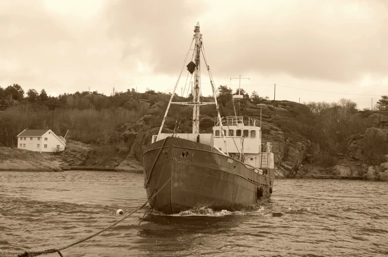 black and white pograph of the rusty old boat near a dock