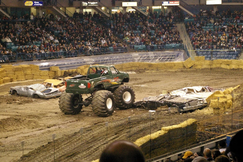 a monster truck is seen riding an obstacle