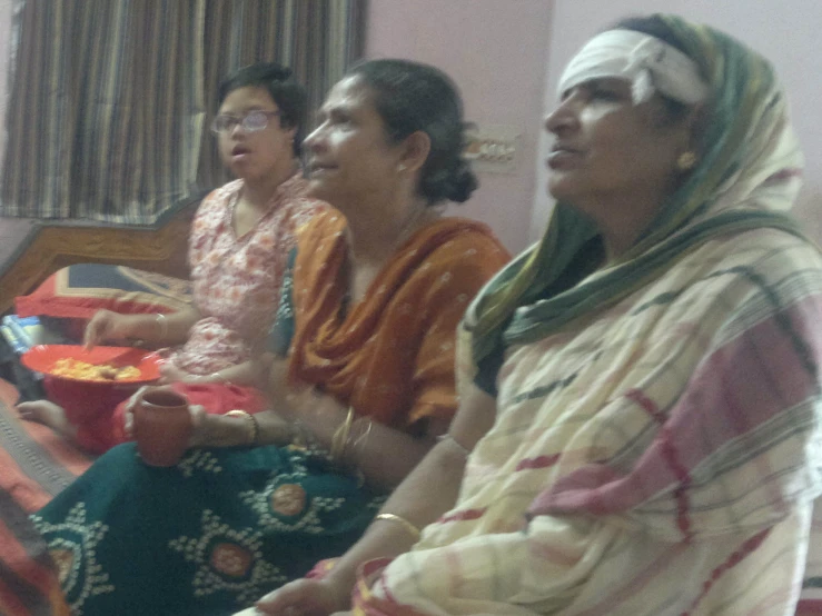 a group of women sitting next to each other in a room