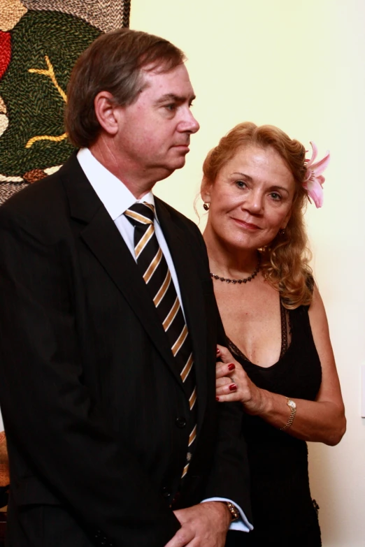 a man and woman are standing together wearing ties