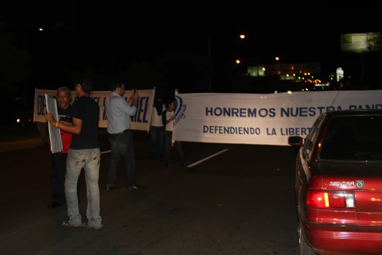 people stand in the road with protest signs