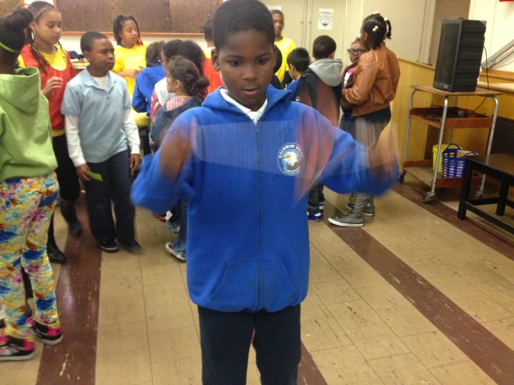 several children wearing warm clothing are lined up in a line