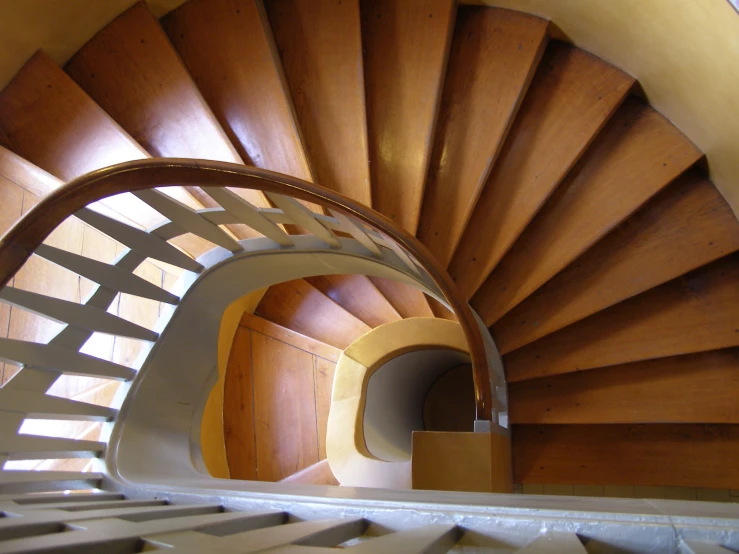 a staircase with wooden railings inside of it