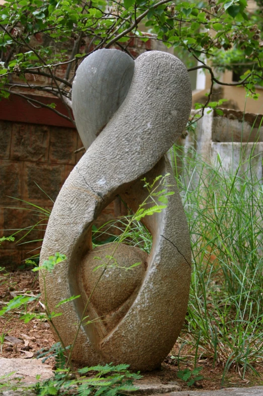 two large rocks stacked up together in a park