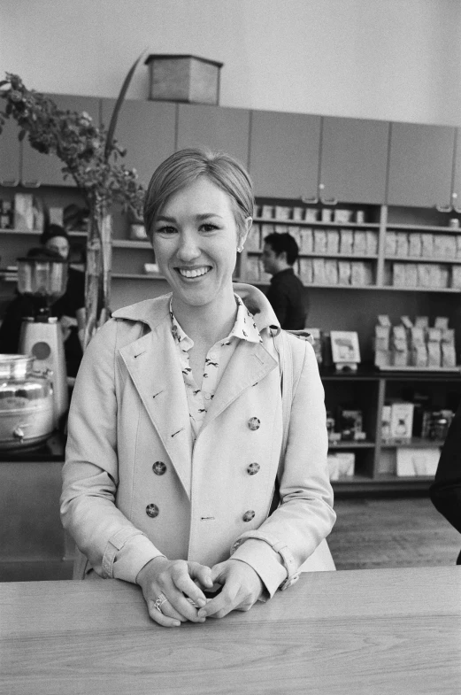 a women who is standing behind a counter