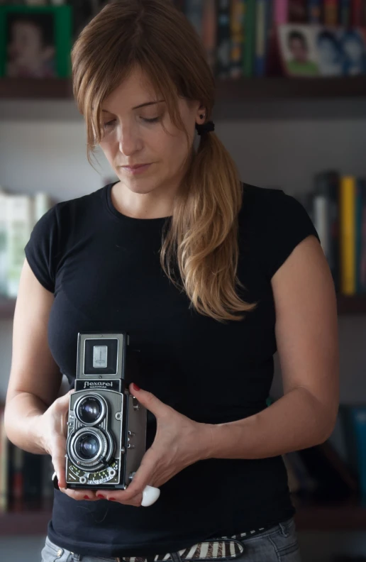 woman holding a camera taking a picture in a liry