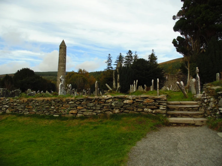 a stone wall that leads up the path