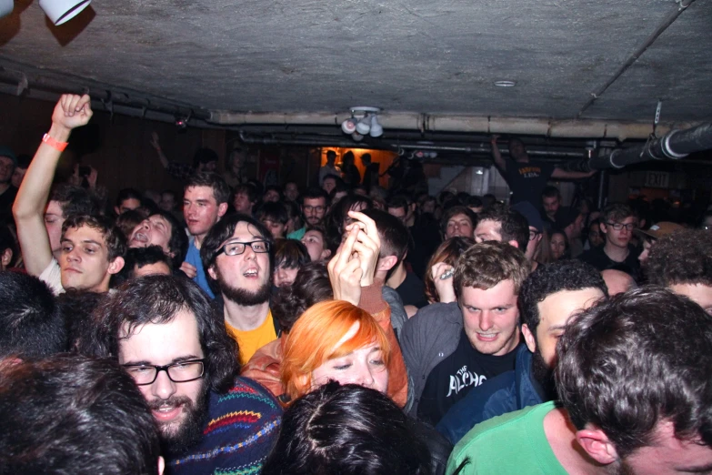 a group of people are dancing in a crowded room