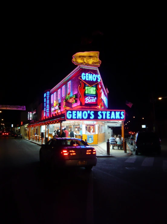 neon lights glow on the shopfront and street