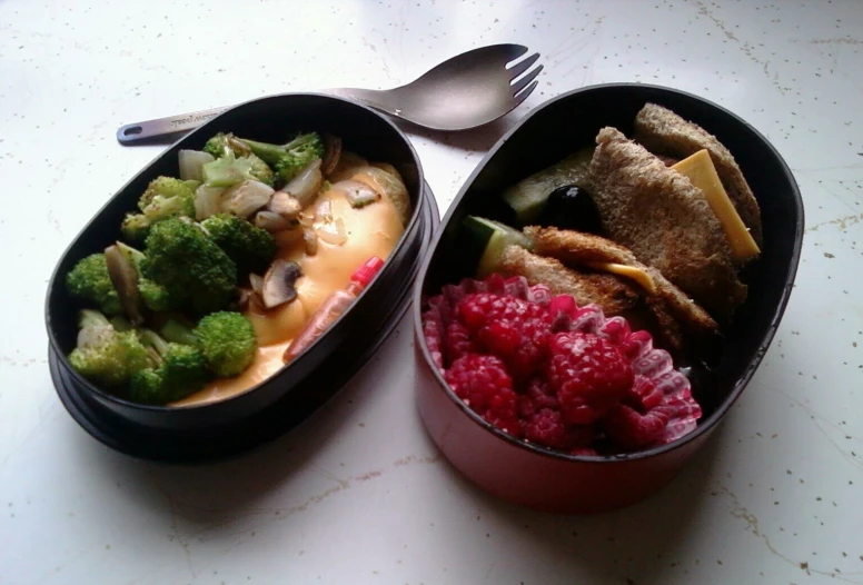 an arrangement of colorful foods and silverware on top of a table