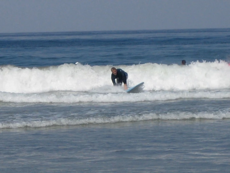 a man is surfing in the ocean with others behind him