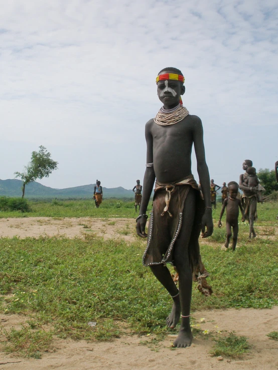 a number of men in costumes and headdress on a field