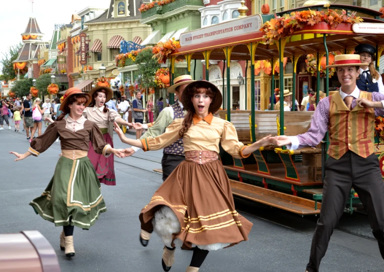 three people in costumes and bonnets dancing in the street