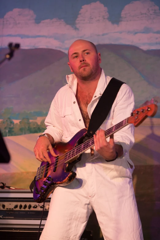 a man plays an electric guitar on stage