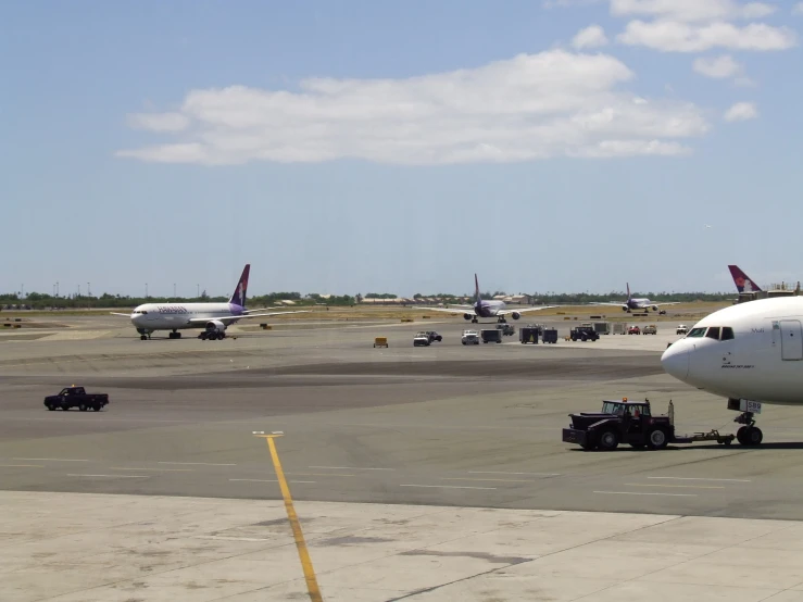 planes and airport workers are on the runway at an airport