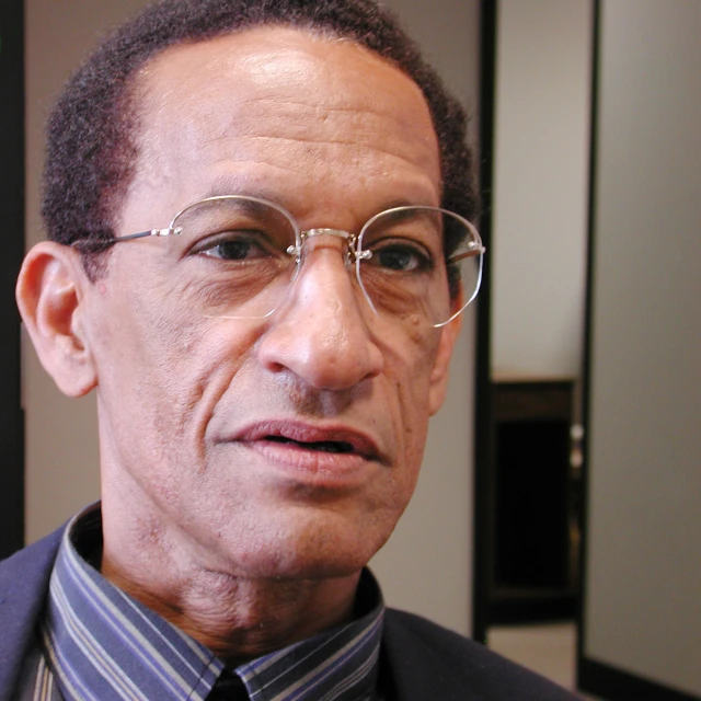 a man wearing glasses and a tie