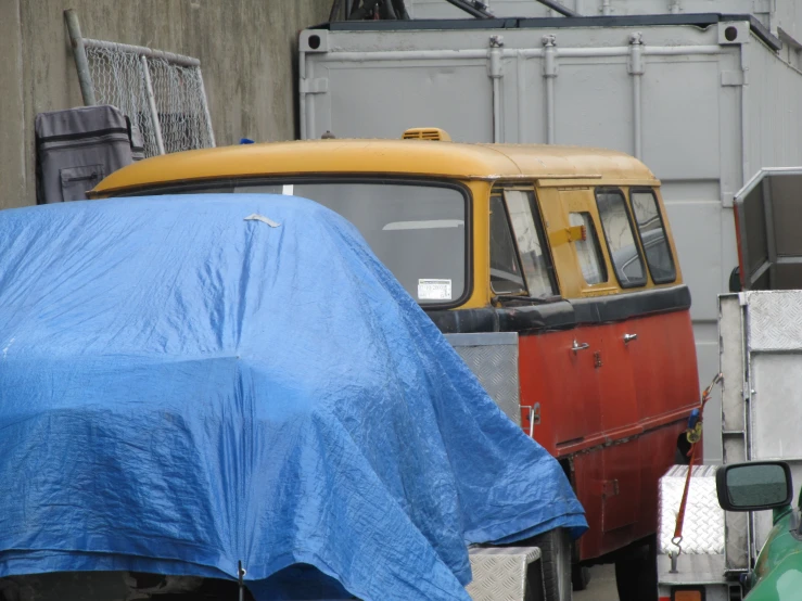 an older bus parked in front of some other vehicles