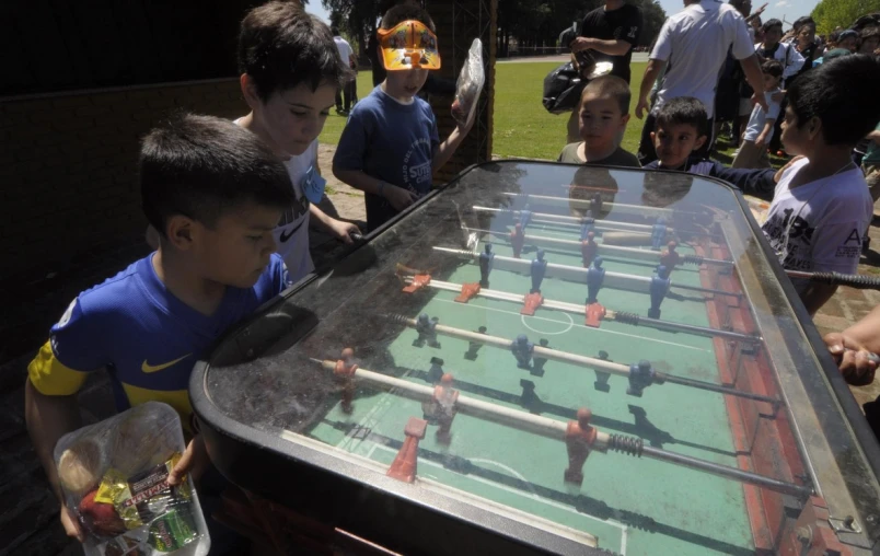 children playing with fooing board in a backyard