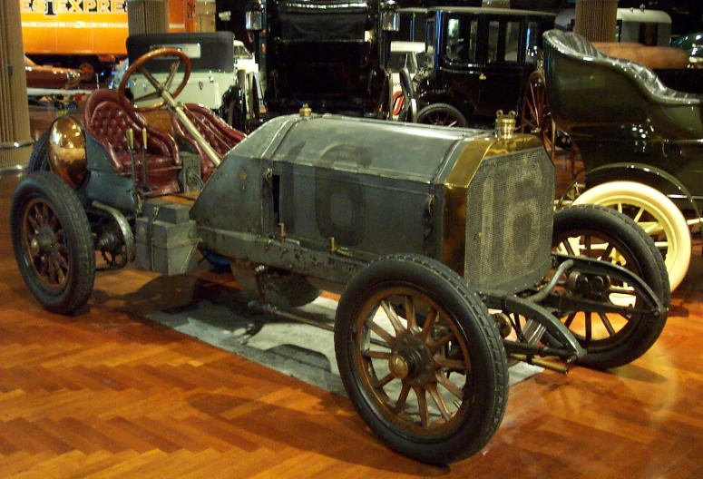 a couple of old fashioned cars on display