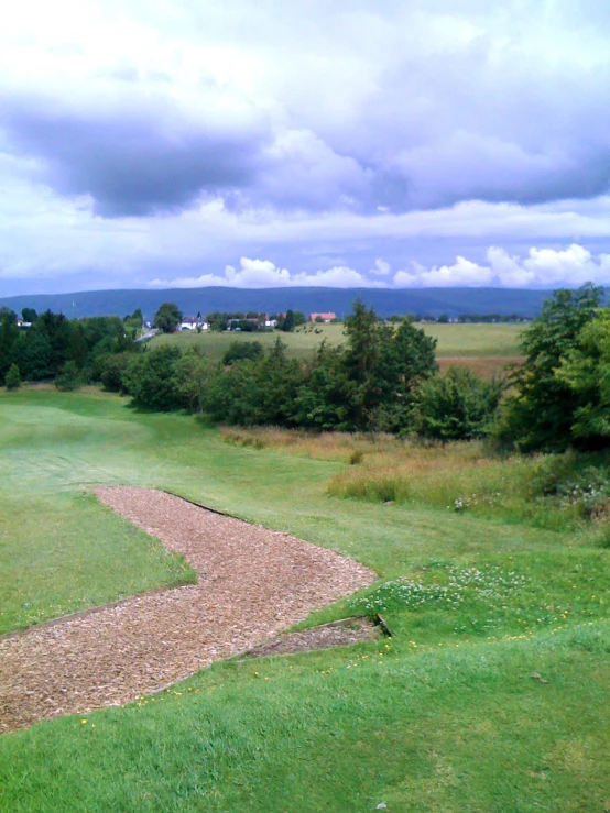 a long narrow path in a green field