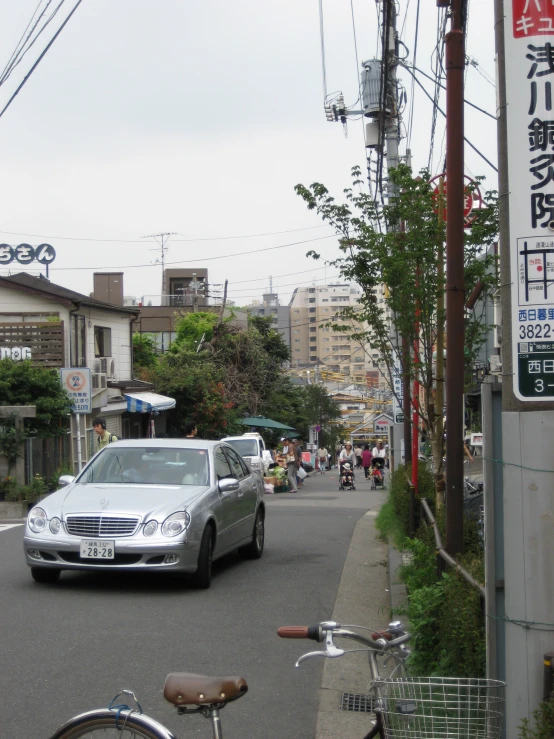 car on a city street in front of a store