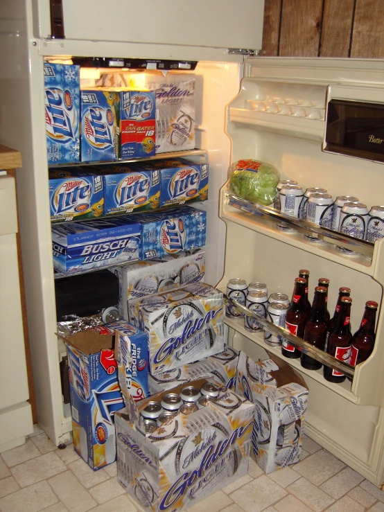 a white refrigerator filled with different types of cans and cans of beer