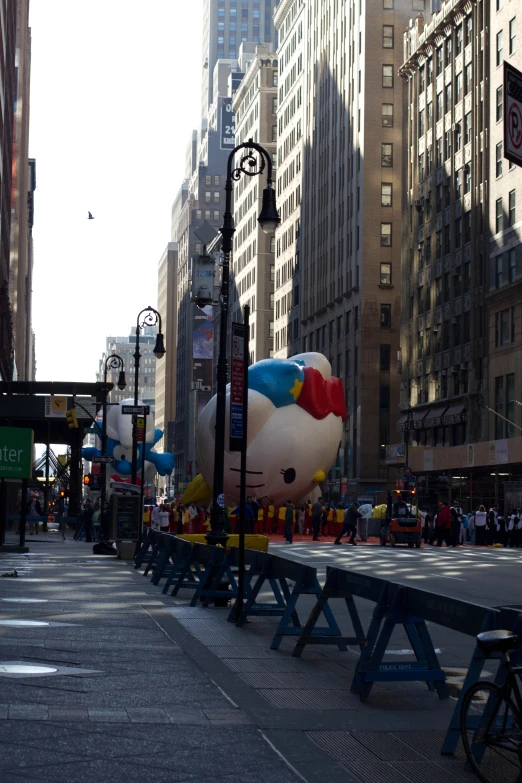 a large hello kitty balloon sitting on top of a picnic table