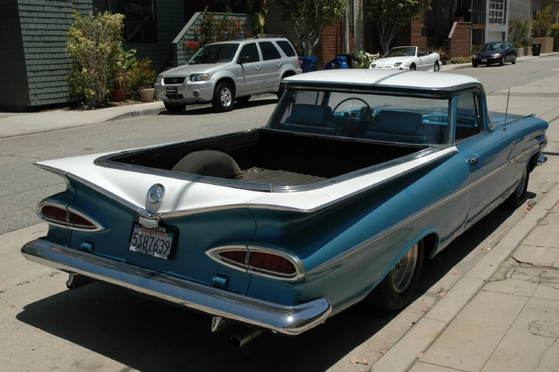 the side of an old school style car on a city street