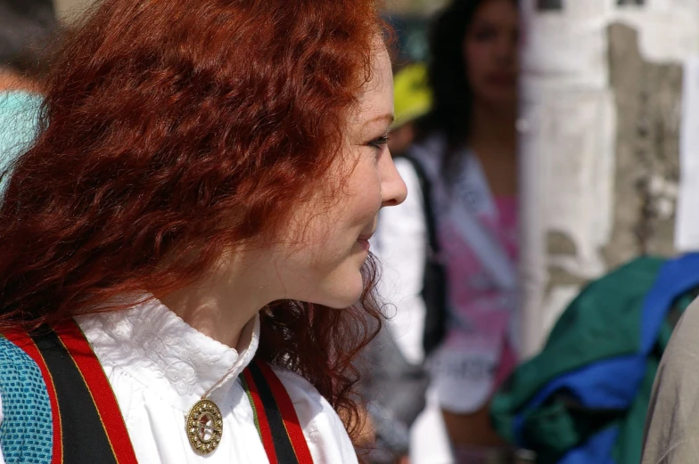 a person with long hair and white shirt