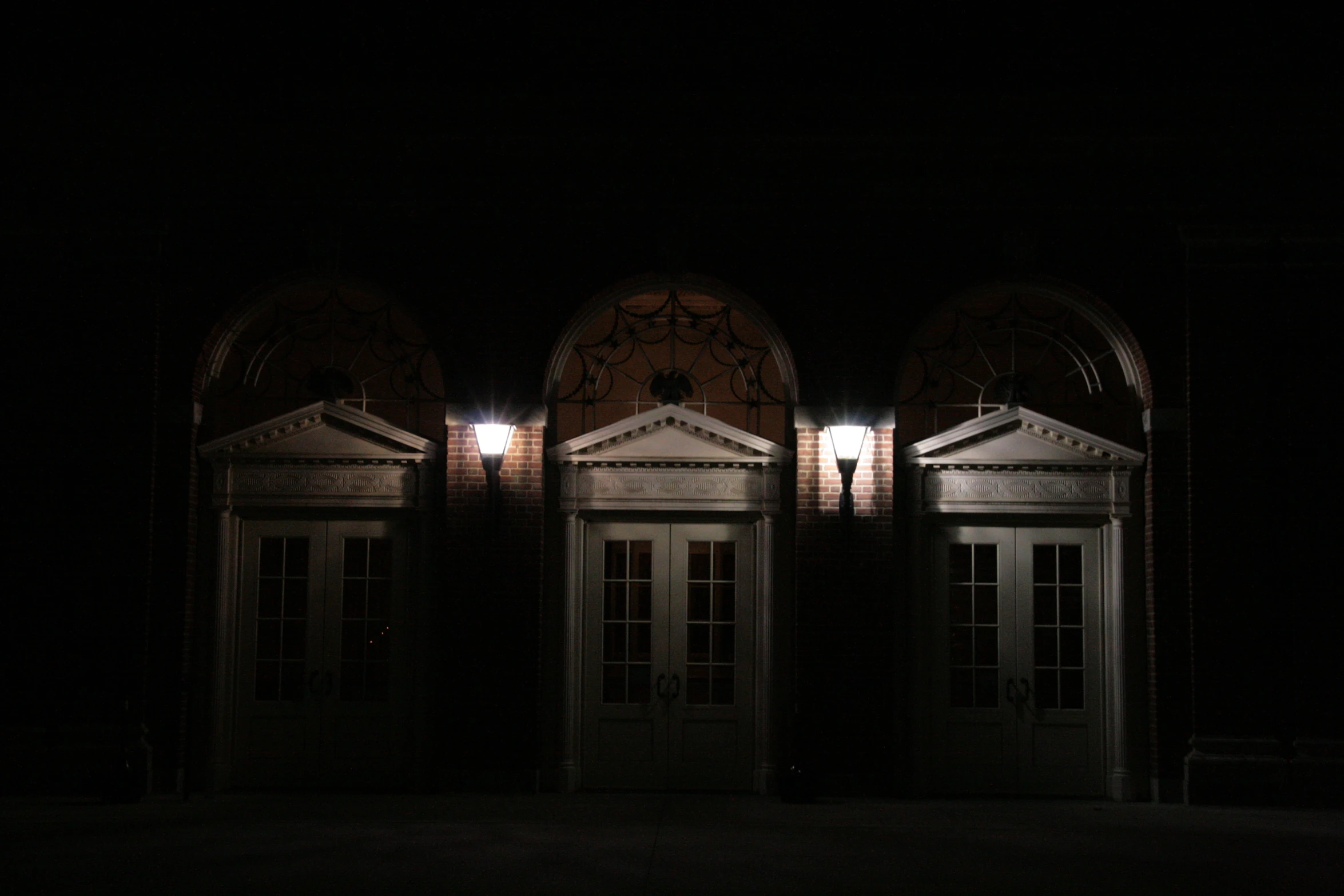 a very dimly lit room with two double doors