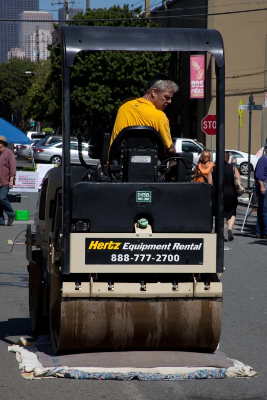 a man sitting in a roller blade mower