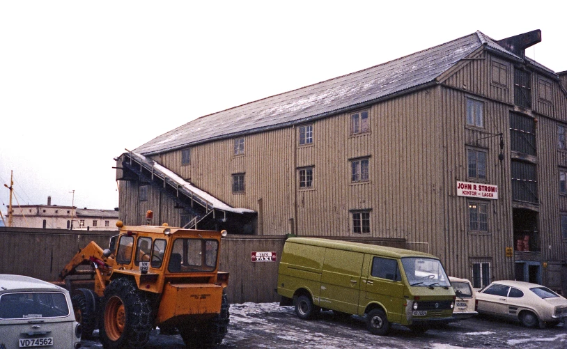 the work truck is parked next to the old building