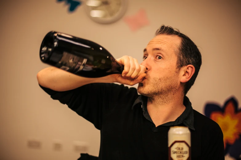 man tasting an old fashioned bottle of beer